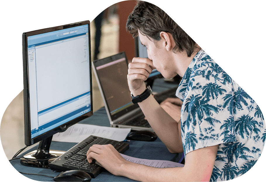 Attendee working on a computer during a workshop.